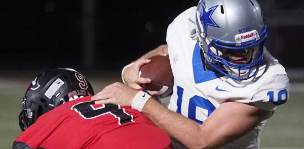 PHOTO: Kilgore College quarterback Judah Holtzclaw fights for extra yardage Nov. 12 at the semi-final playoff game in Athens versus Trinity Valley.